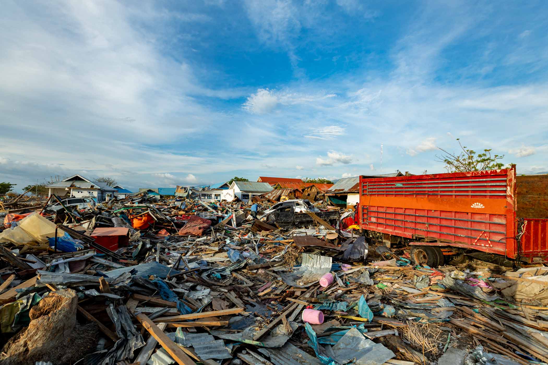 The scattered debris of buildings and cars after tsunami disaster swept Palu in 2018.